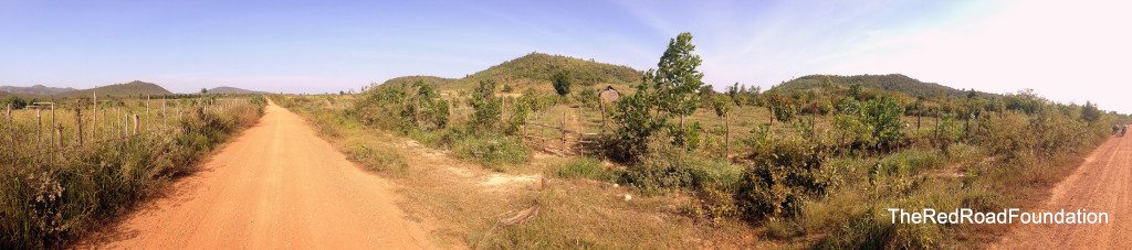 This picture shows the neighboring property, owned by the village chief. He is currently growing mango and banana trees on the plot. Our prospect for the project site starts on the right hand side of the picture where the bikes can be seen and stretches up the line of trees you can follow t o the base of the mountain.